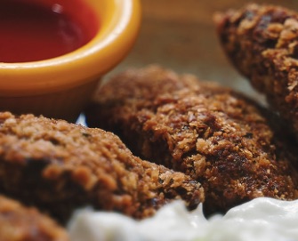 Photo of falafels with red sauce and yogurt