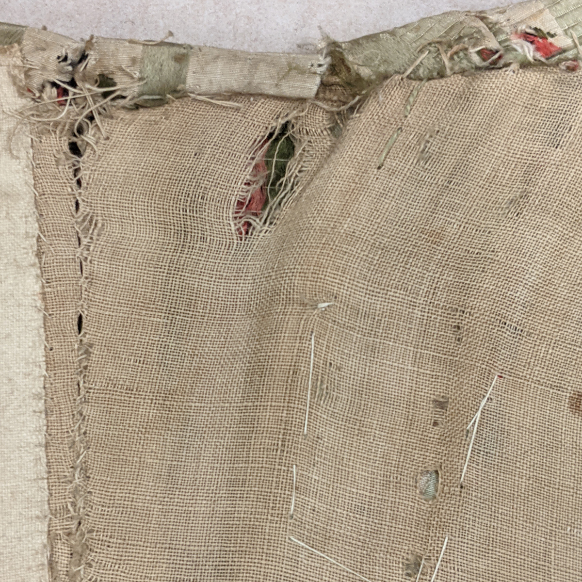 Another gown from the 1700s in our collection shows patching to mask a rip to the lining, and re-sewn seams: