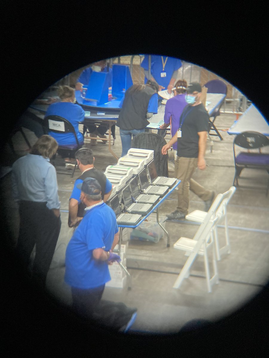 In the middle of the room are five laptops and five printers. But they don’t seem to be printing anything at the moment  #azauditpool