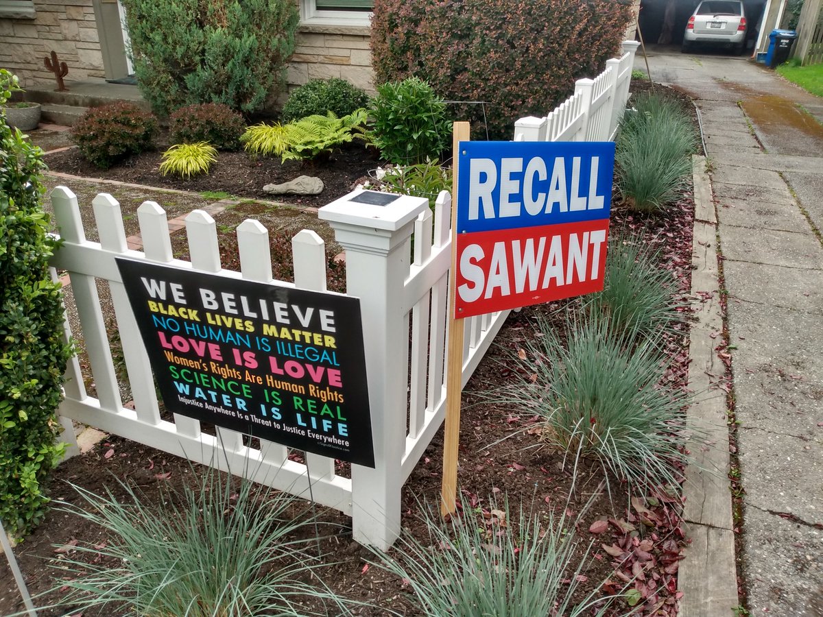 mbsycamore's tweet photo. The unintended irony of "RECALL the only city council member who actually supports social justice" and "WE BELIEVE Black Lives Matter..." in front of the same white picket fence is so Seattle it hurts. https://t.co/JRXhoTr4lK