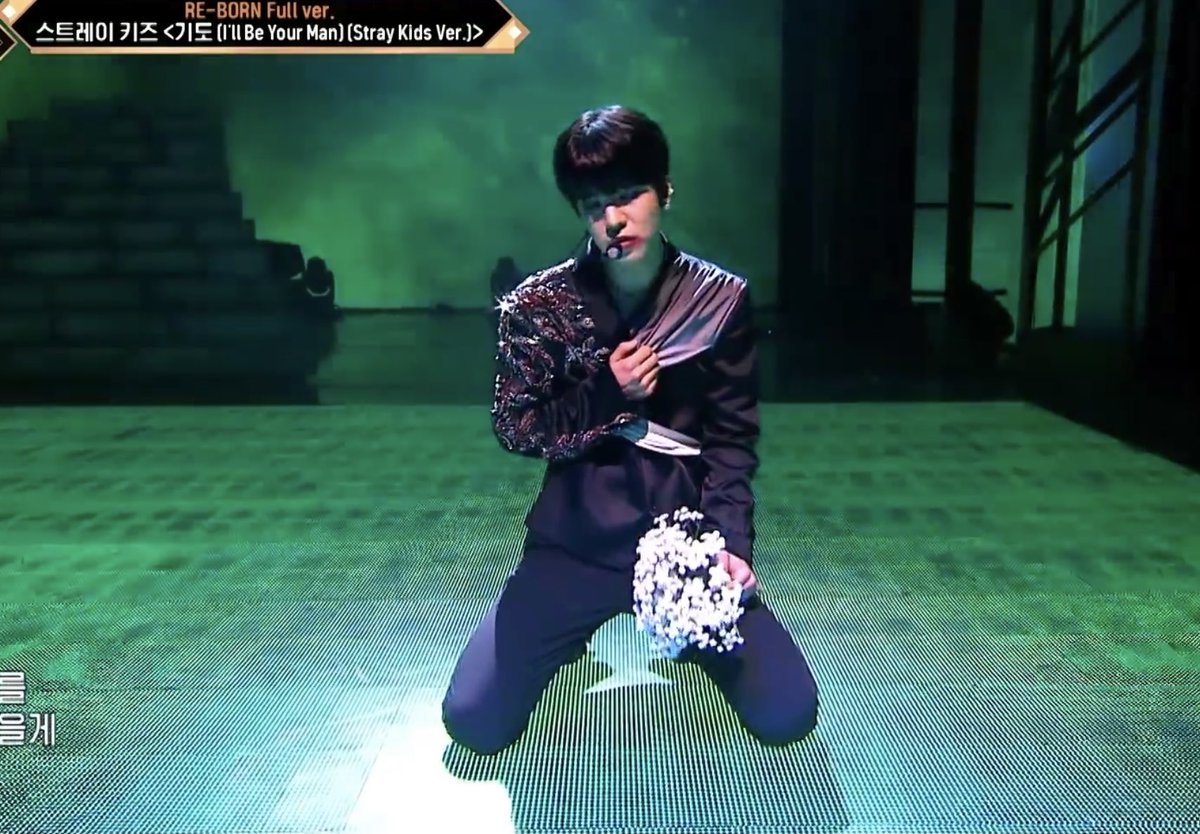At the beginning of the performance, seungmin kneeled in front of the statue of the boy with a flower for him, indicating that the boy is someone they lost.Lighting: blue/green - regret, sadness
