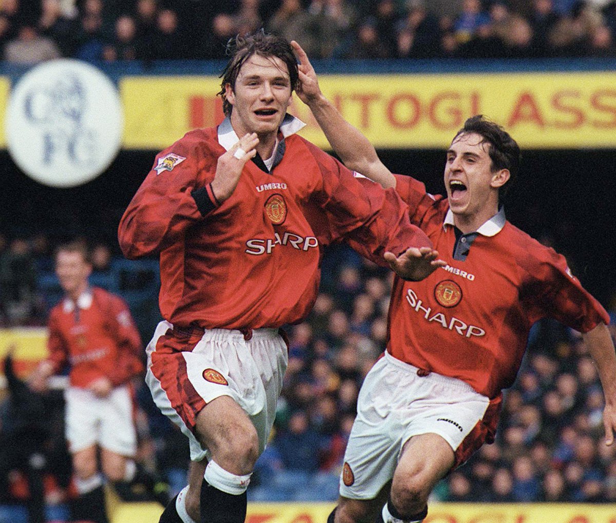 Meanwhile, United were on a roll - and heading into a 'treble' season. Here's David Beckham celebrating his goal with Gary Neville as United beat Chelsea 3-5 at Stamford Bridge in the FA Cup.