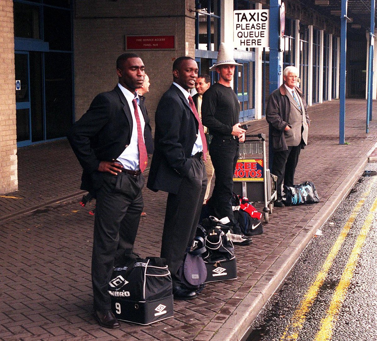 And Andy Cole and Dwight Yorke waiting for a taxi at Manchester Airport after arriving back from Munich - they'd drawn 1-1 with Bayern Munich in the UEFA Champions League group stages. The next time the teams would meet would be in the final.