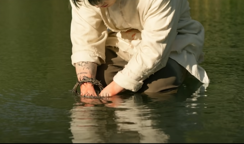 Going back to Jungkook, he seems to have found the perfect spot for baptism!He goes into the lake & lowers his thorn-bound wrists."Repent & be baptized... in the name of Jesus Christ for the forgiveness of your sins, and you will receive the gift of the Holy Spirit" - John 14:6