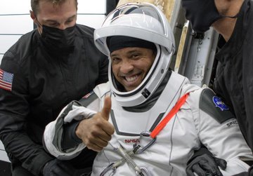 NASA astronaut Victor Glover is helped out of the SpaceX Crew Dragon Resilience spacecraft onboard the SpaceX GO Navigator recovery ship after he, NASA astronauts Mike Hopkins, Shannon Walker, and Japan Aerospace Exploration Agency (JAXA) astronaut Soichi Noguchi, landed in the Gulf of Mexico off the coast of Panama City, Florida, Sunday, May 2, 2021.