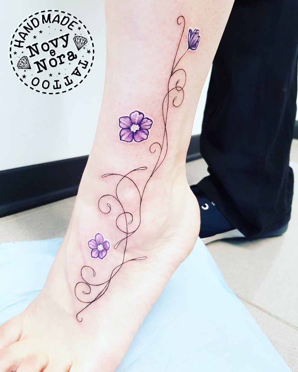 Flower bouquet tattoo located on the ankle.