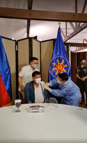 ABSCBNNews's tweet photo. LOOK: President Duterte receives Sinopharm's COVID-19 vaccine. The shot was administered by Health Sec. Francisco Duque III. https://t.co/PfuSJyT0mN