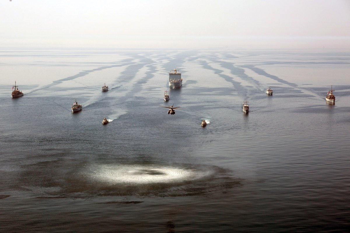 A group shot of the Artemis Trident 21 participants with RFA Cardigan Bay centre rear