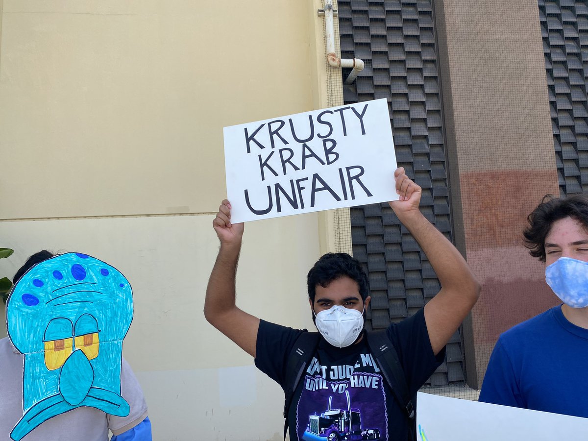 “Krusty Krab Unfair” and “Valet Parking” among the counter protesters’ signs