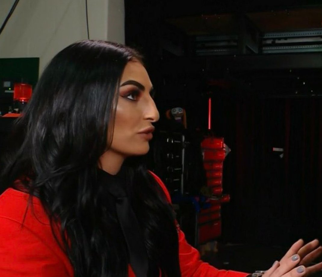 Sonya Deville backstage with Alexa Bliss' doll, Lilly, in the background.