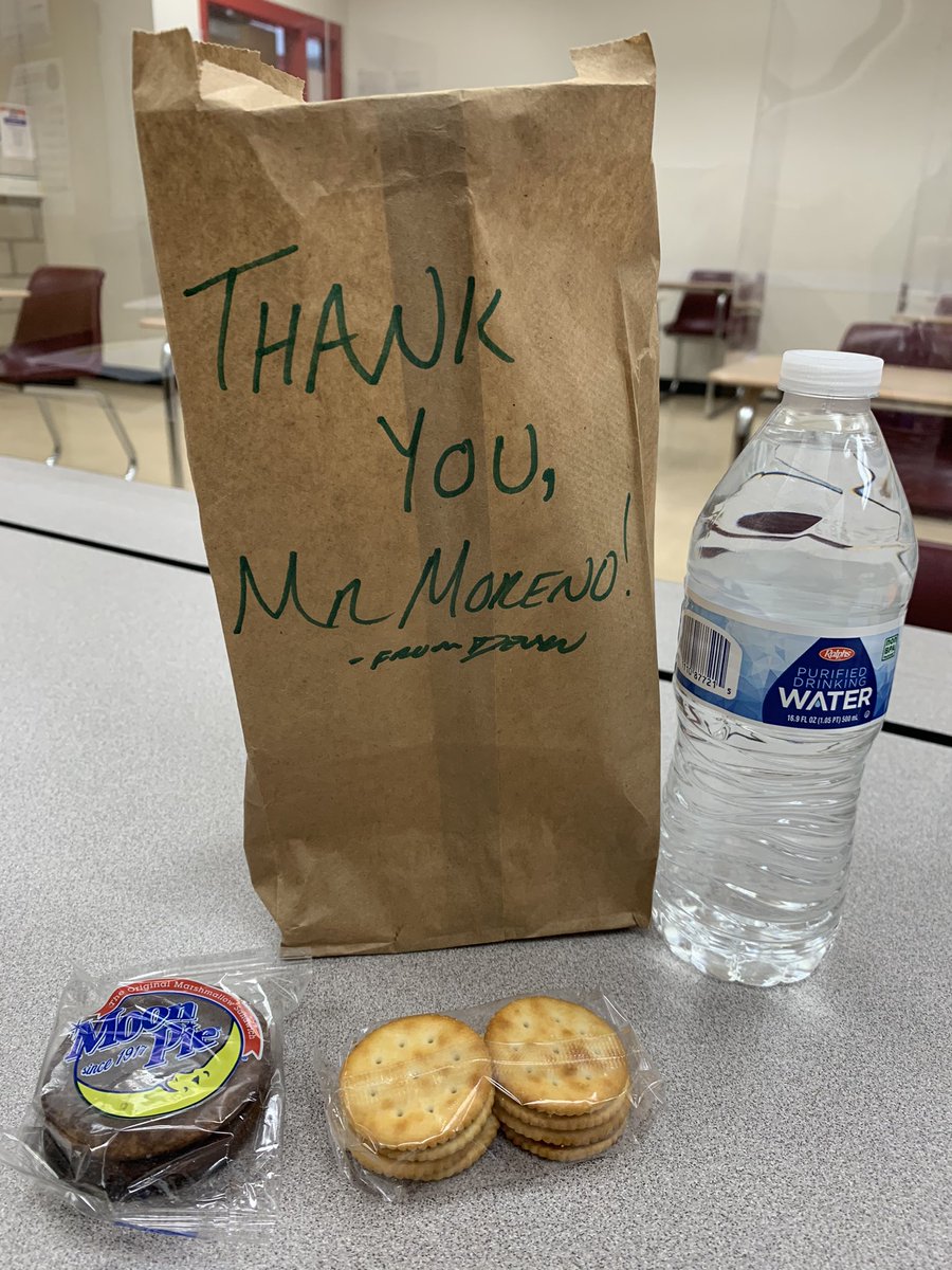 JacobMorenoIII's tweet photo. It’s been the longest and most challenging year of our careers, but we’re still standing! And sitting, and zooming, and prepping, and planning, and teaching. Happy Teacher Appreciation Week! Much love to my wife for the Starbucks’ card and my student for the snacks and water. 🍎 https://t.co/UkAiVAy4fF