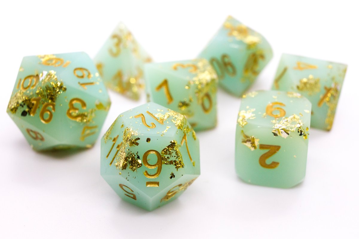 Handmade resin dice in a pale greenish blue with gold leaf foil and gold ink, minor flaws on some of the facets that face the lid --> 60 Euro excluding shipping.