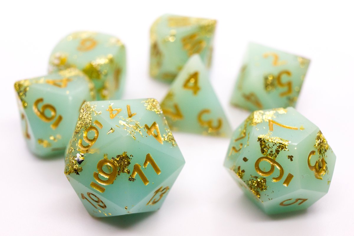 Handmade resin dice in a pale greenish blue with gold leaf foil and gold ink, minor flaws on some of the facets that face the lid --> 60 Euro excluding shipping.