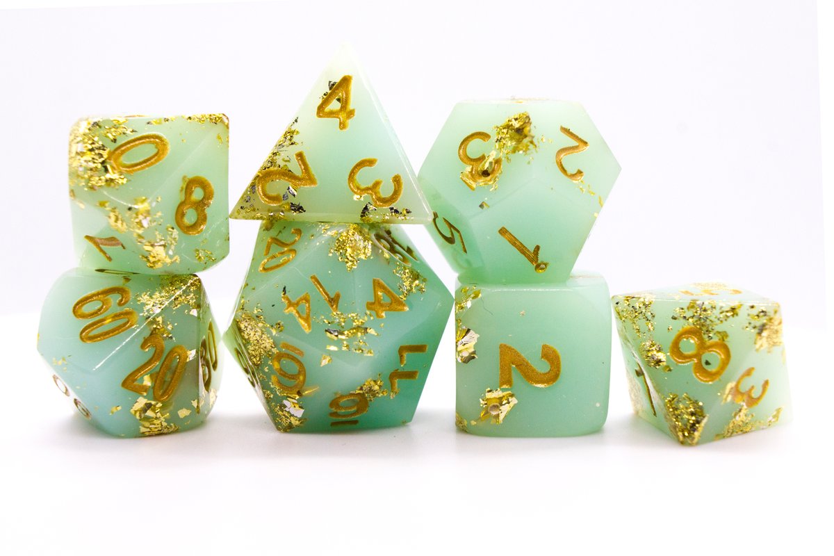 Handmade resin dice in a pale greenish blue with gold leaf foil and gold ink, minor flaws on some of the facets that face the lid --> 60 Euro excluding shipping.