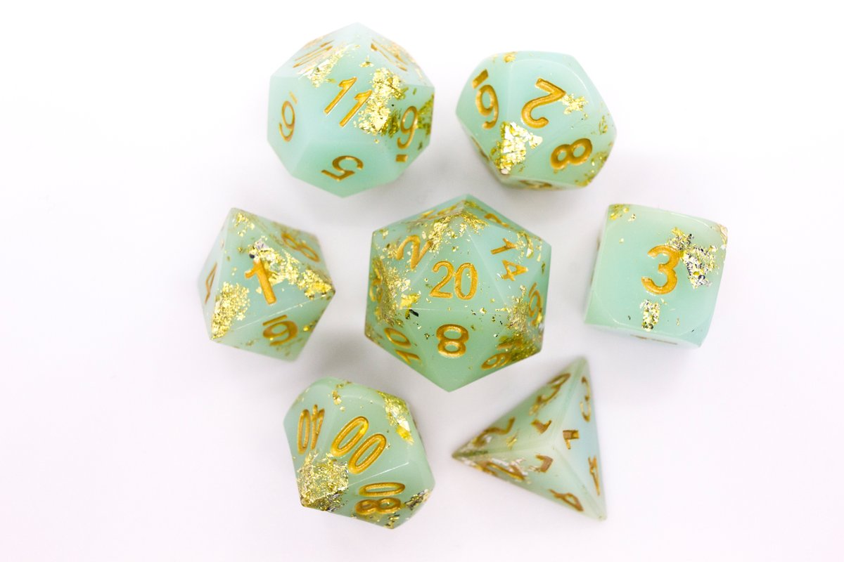 Handmade resin dice in a pale greenish blue with gold leaf foil and gold ink, minor flaws on some of the facets that face the lid --> 60 Euro excluding shipping.