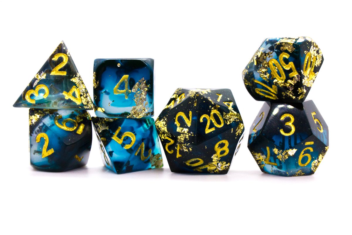 Handmade resin dice in dark blue and black with gold leaf foil and gold ink, tiny air bubbles inside some of the dice if you watch very carefully --> 65 Euro excluding shipping.