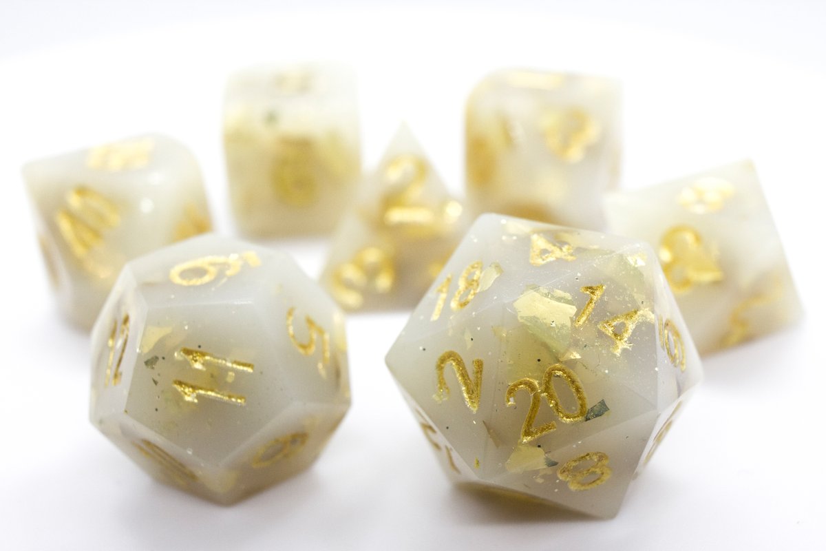 Handmade resin dice in a milky shade of white with gold leaf foil and gold ink, very minor flaws on some of the facets that face the lid --> 50 Euro excluding shipping.