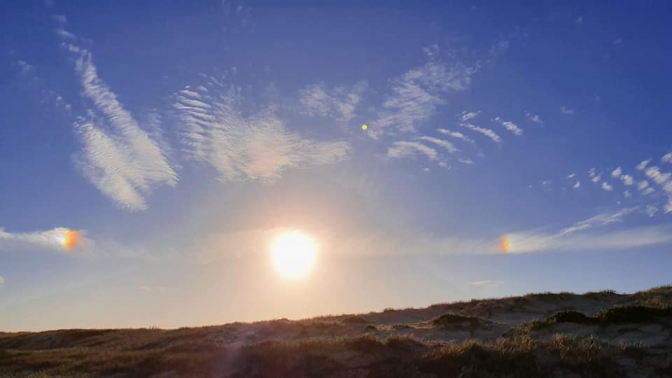 ruggo's tweet photo. @BOM_au can you advise what causes the rainbow colours on the clouds either side of the sun? Taken at Hawks Nest, NSW. https://t.co/j3QrCXIKHo