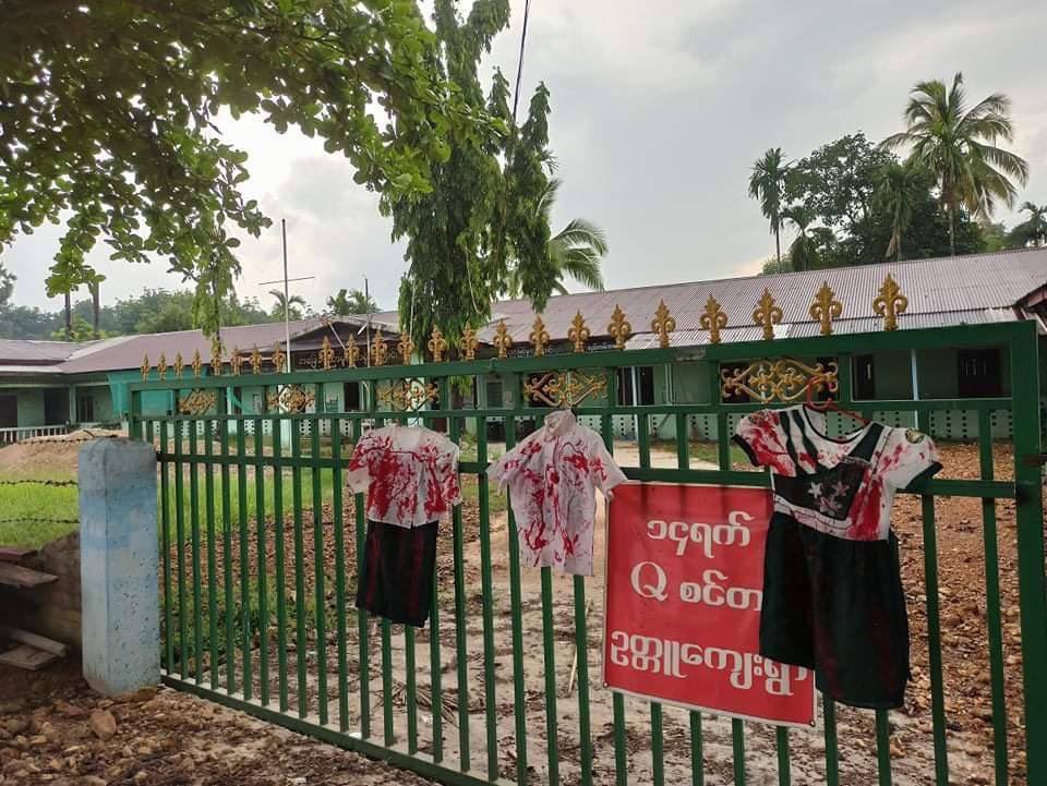 EiPont22's tweet photo. Students from Ottu Village, Thayet Chaung protest against military slavery education system and hanged red painted school uniforms on the fence of the school. #WhatsHappeningInMyanmar  #May6Coup  #OpposeSlaveryEducation https://t.co/KjJjsIoOVB