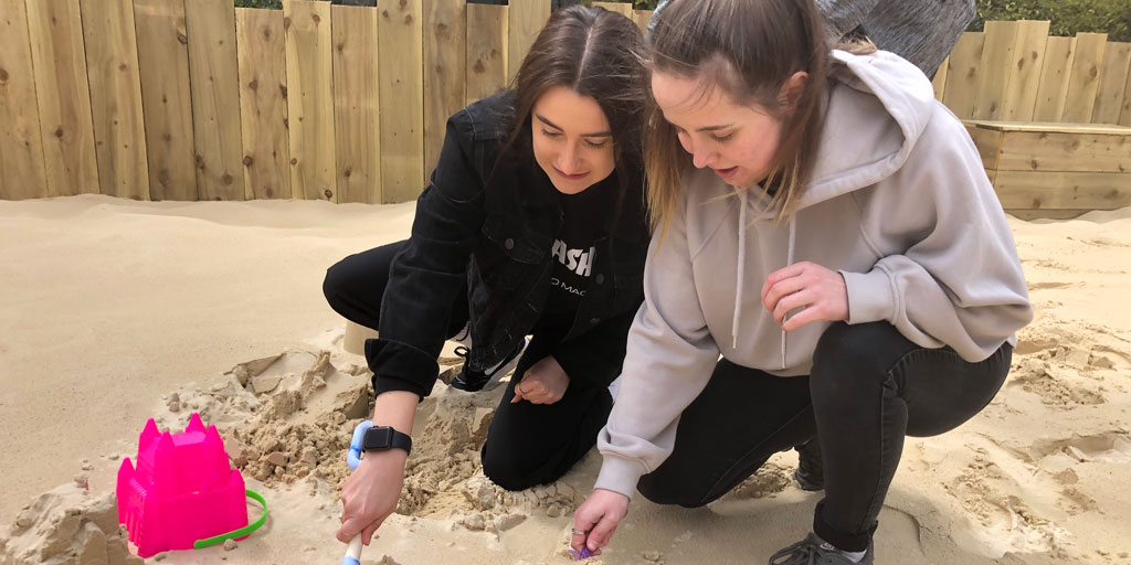 Two students on the beach at Marjon