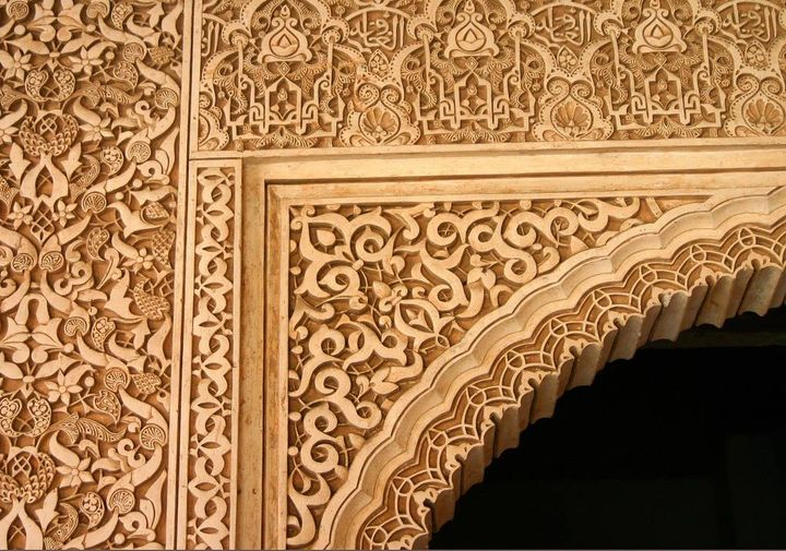 Calligraphy and geometric designs at the Alhambra Palace in Granada, Spain. Built in the 1300s by the Nasrid Dynasty.