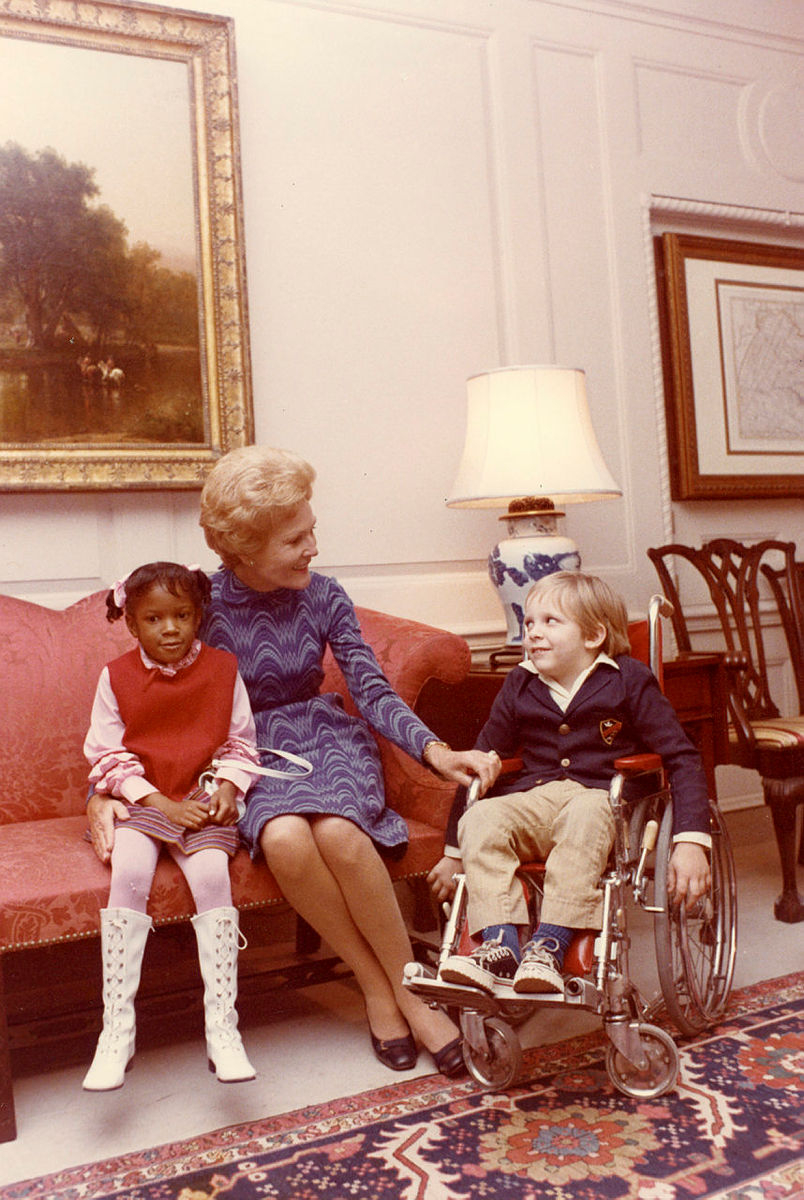 On October 21, 1971, children from the Washington Hospital for Sick Children visited the White House. In this photo, Mrs. Nixon sits with patients Dorothy Anderson and Sean McCombs in the White House Map Room. Image: Richard Nixon Presidential Library and Museum/NARA