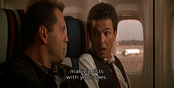 The man sitting next to him advises him to take off his shoes and "make fists with his toes" once he arrives. I don't need to tell you where this is leading, but what needs to be said is that…