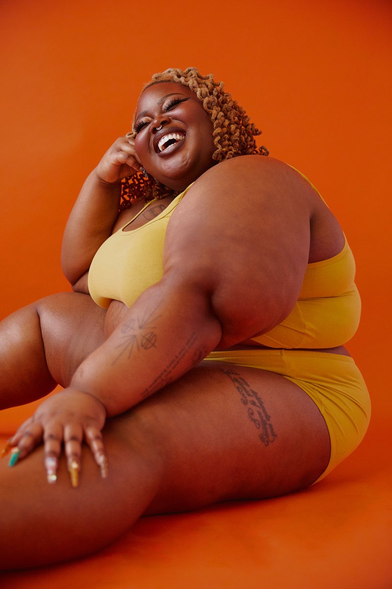 "i love seeing the way my skin and face shine against the orange background. we subverted the traditional calvin klein campaign aesthetics (thin, white, non-disabled) for a underwear shoot that explicitly celebrated my fatness & Blackness " —  @savagexfatty (they/them)