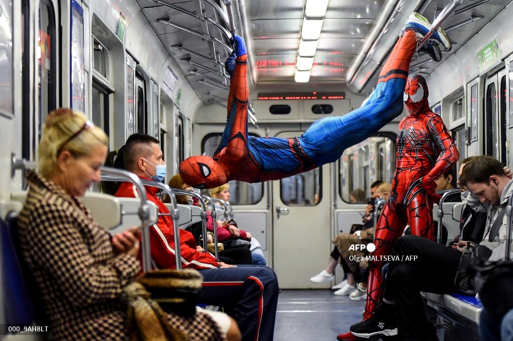 Underground dancers dressed in Spiderman costumes perform in the subway of ...