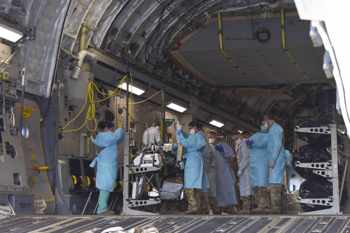 DoD_DHA's tweet photo. Airmen transported a #COVID19 patient onto a C-17 Globemaster III at #JBLM to take the patient to #SAMMC last month. The patient was in severe respiratory distress and was hooked up to an extracorporeal membrane oxygenation system to aid breathing. #UnifiedReliableReady https://t.co/DqLyJhAJcD