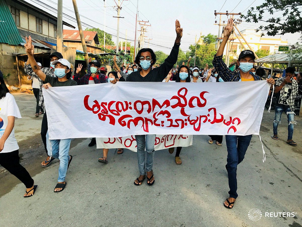 walone4's tweet photo. Students hold a banner and flash the three-finger salute as they take part in a protest against Myanmar’s junta, in Mandalay, Myanmar May 10, 2021. #WhatsHappeningInMyanmar https://t.co/BtfPyjvlcU