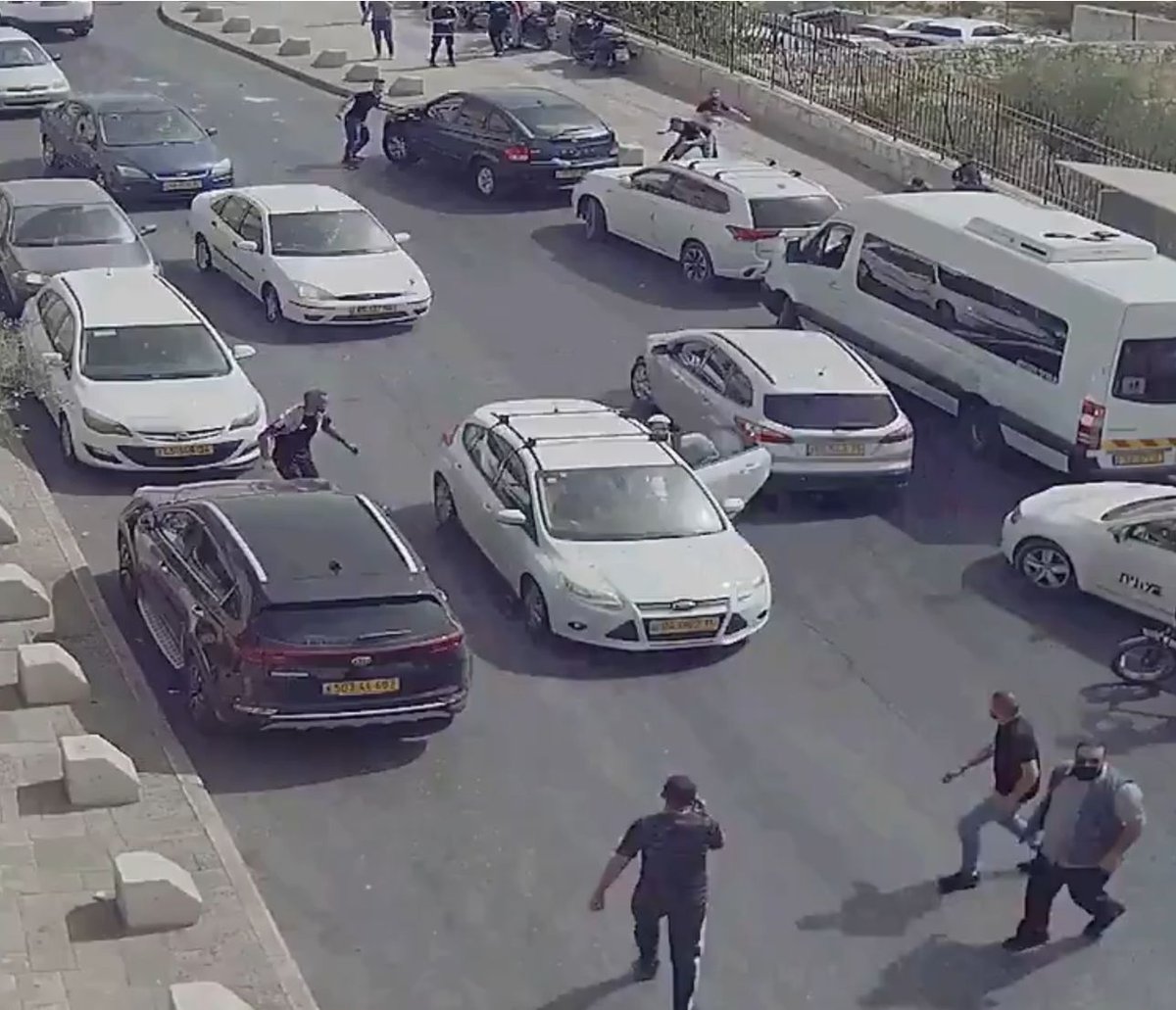It is just four seconds long. It opens with one Palestinian about to accost the vehicle. However, we can tell that something has happened prior to the opening of this video. The driver’s side door is open. People in the background appear to be taking cover.