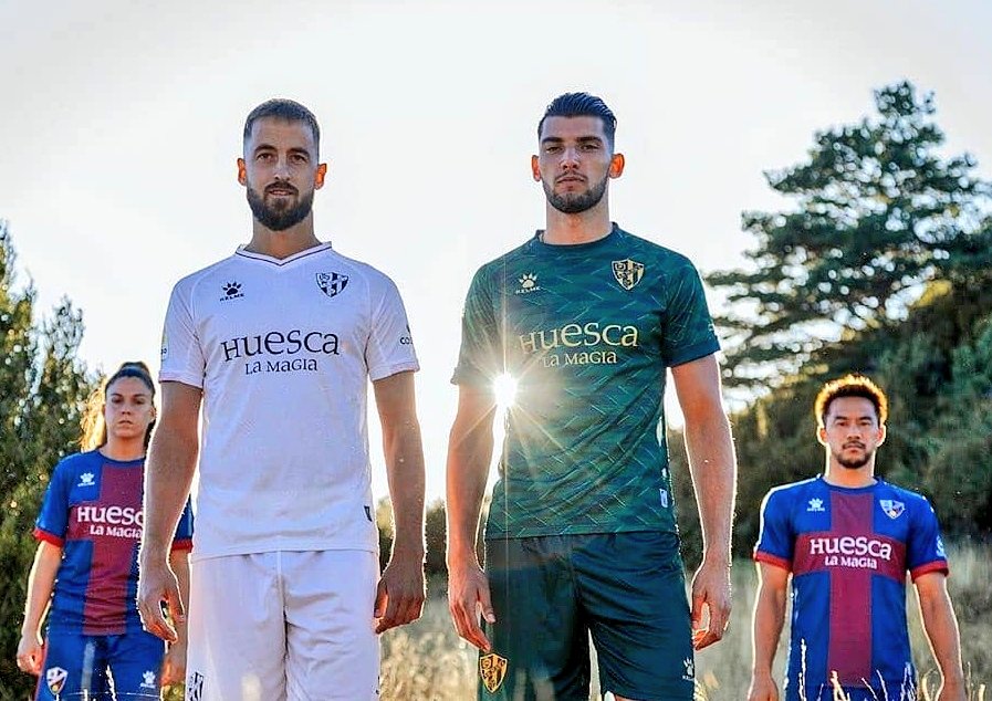 The_Kitsman's tweet photo. The @SDHuesca trio are exceptional. I like how they've put the home shirt towards the back here. The away and third shirts are glowing in the sunset. Love the gold detailing on those.

#KELMEWeek🐾 https://t.co/DLv7u0ciQO