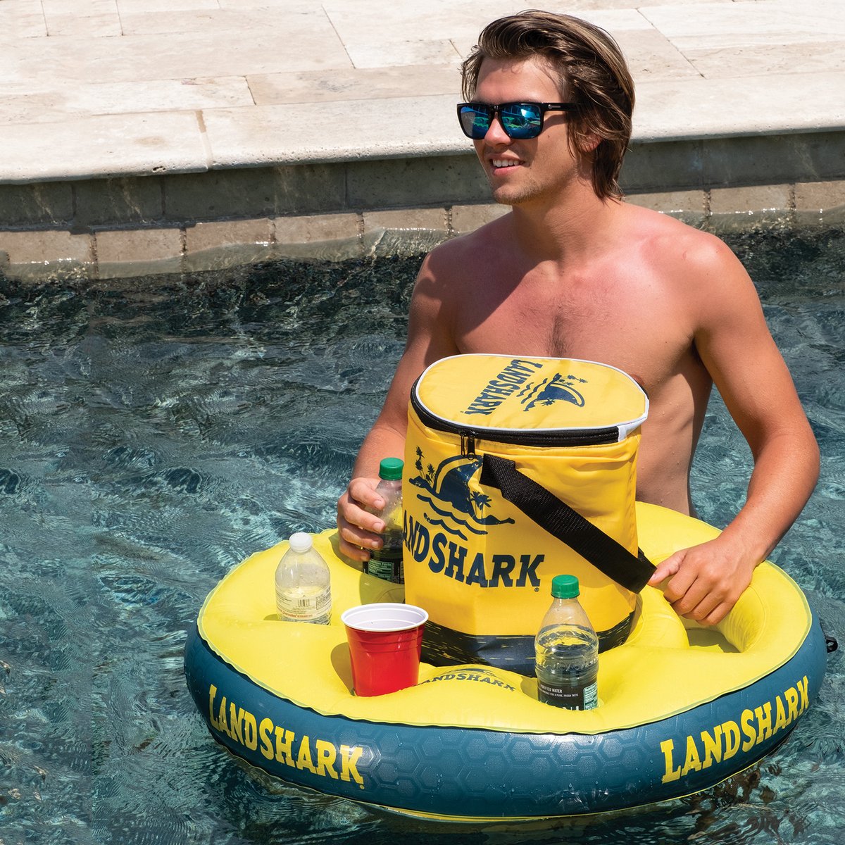 SunsportsME's tweet photo. Bring the party to the water with the LandShark Float N Go drink and snack holder! Featuring five drink holders, a snack tray and a removable cooler that keeps up to 12 beverage cans cold, you can enjoy the party without having to leave the pool for refills. https://t.co/JJGeNntibi
