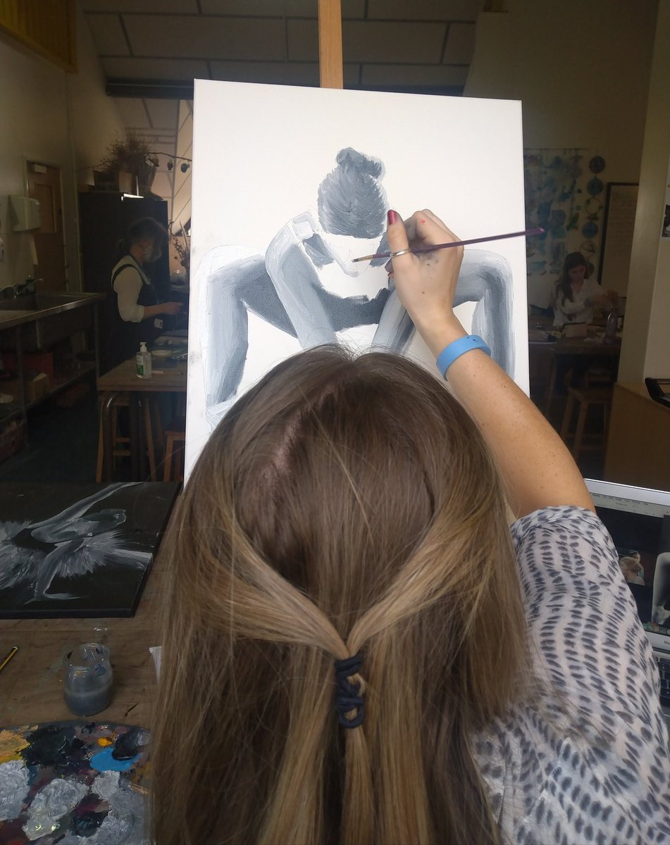 Grace paints in grisaille. Oil paints emerging from last night from photographs of fellow student.