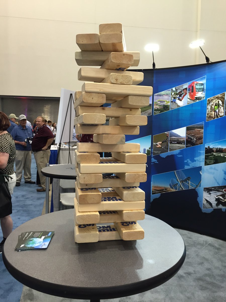 CaufieldBA's tweet photo. Who dares play the @CDMSmith 2x4 Jenga? Only the brave! (that shipping box was so heavy!) Milling around outside during fire evacuations. The Booth crew enjoying a meal and each other's company. #ASFPMthrowback https://t.co/gTFxYZJg7Z