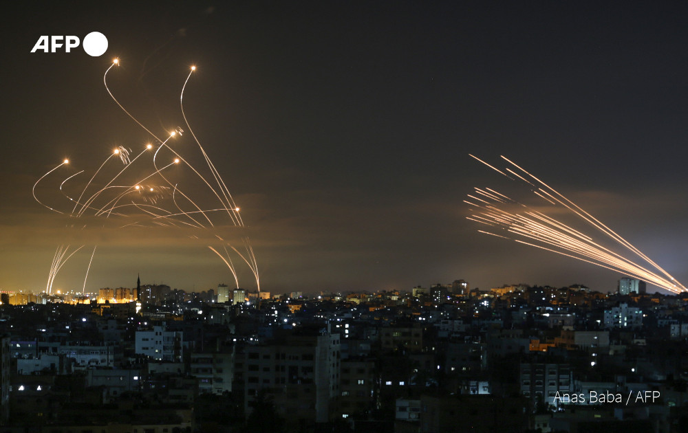 Israel's Iron Dome defence system and rockets launched from Beit Lahia in the Gaza Strip rise into the night sky on May 14

📸 Anas Baba