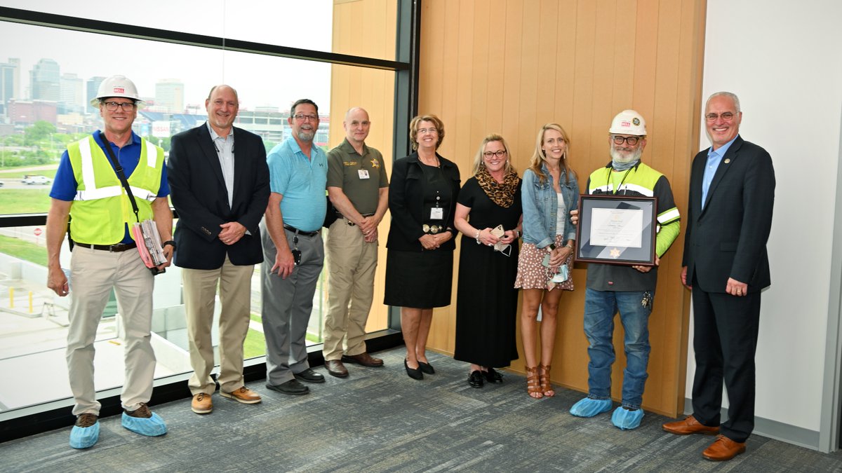 BELLConstCo's tweet photo. In celebration of our completion of the @NashSheriff HQ project (ahead of the original schedule!), @DaronHall7 & the DCSO surprised #BELLConstruction Superintendent Tommy Carr with an ⭐Honorary Deputy Sheriff's badge⭐ & certificate. We are so proud of Tommy and our team! https://t.co/mAzqhDDfpx