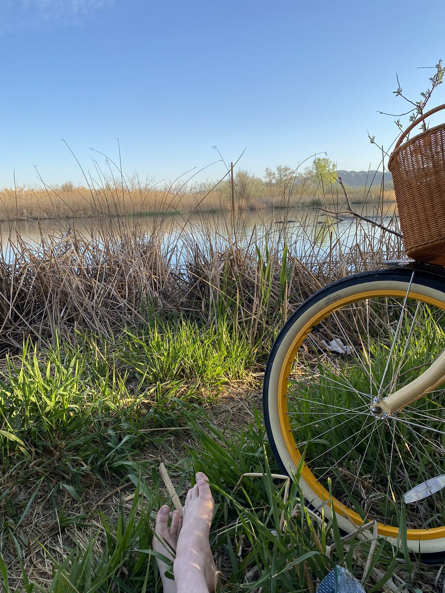 Feet and a bike by a body of water