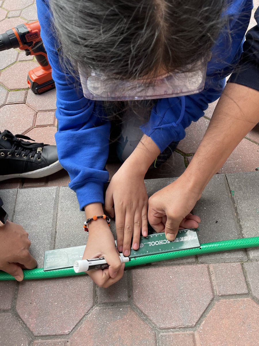 This was our solution to our soaker hose! We got a hose from our school and made our own soaker hose! We drilled holes into the hose with safety precautions. Now we have a soaker hose we can use in our area and put in the path we shoveled. #stem #RainwaterAndMosquitoesTrap