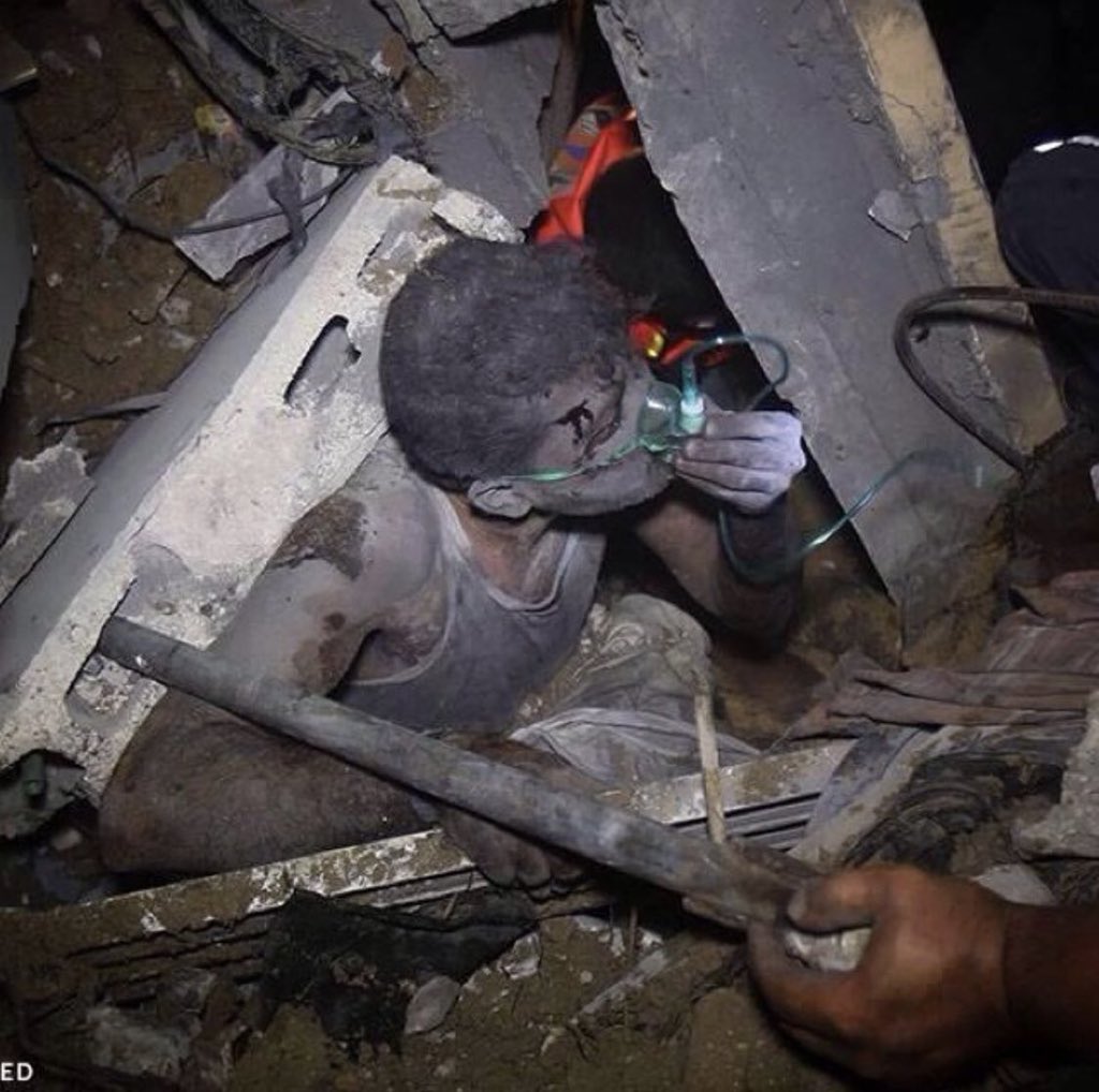 A child under the rubble of his house, after it was bombed by the Israeli army with warplanes .
#PalestineUnderAttack
#GazzaUnderAttack 
#PalestineBleeding