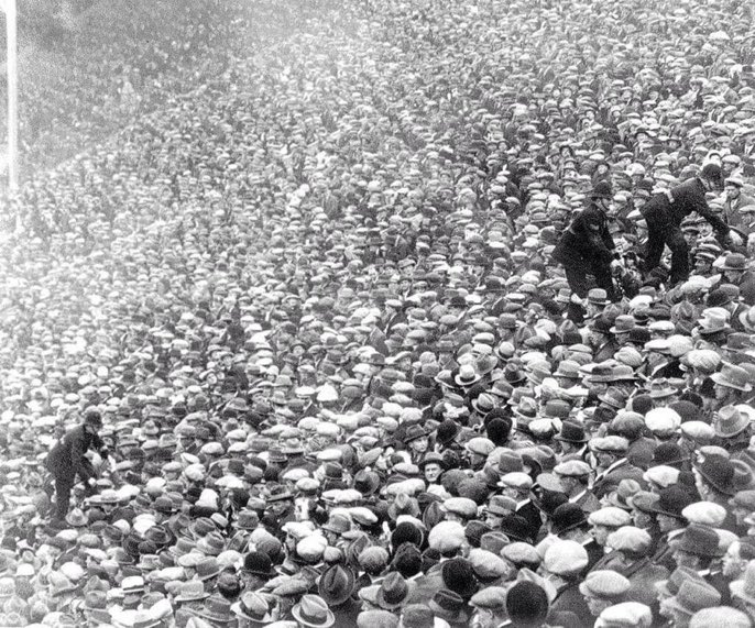 Policemen climb over supporters to get through the crowd during the 1927 FA Cup final between Arsenal &amp; Cardiff at Wembley #FACupFinal #AFC #CCFC