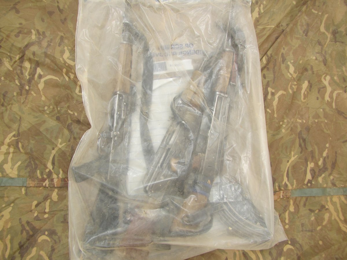 Three of the AK47 rifles found in the search operation inside an evidence bag.