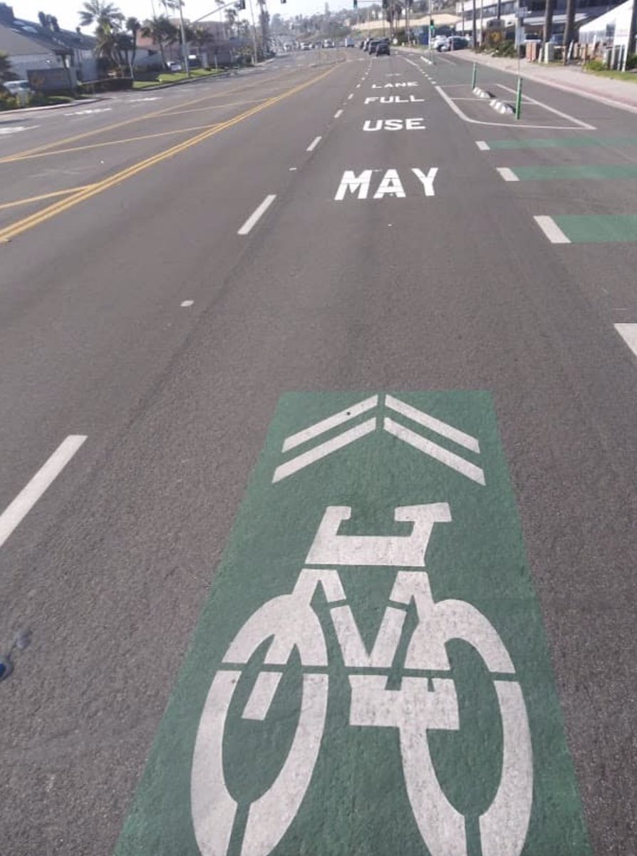 Pflax1's tweet photo. First time I've seen this. Kind of underscores that the meaning of the sharrow symbol is mysterious to most drivers—now they're painting a complete sentence on the pavement to make it clear. Sharrows are bullshit. https://t.co/cLSjVM5SBn
