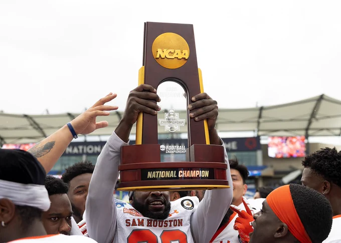 Football player holds up trophy!