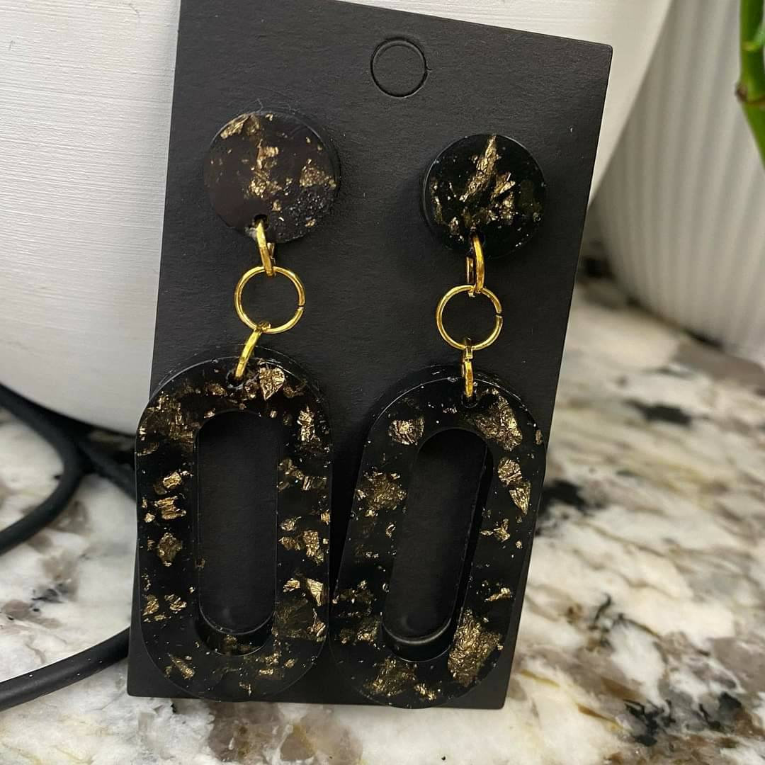 Lovin' these black and gold flake resin earrings!  Order a pair today from our #Etsy shop! etsy.me/3yjo8Db #black #gold #women #resin #surgicalsteel #resinearrings #postearrings #giftideas #giftsforher #love2jewelry #funwithresin #resinart #blackandgold