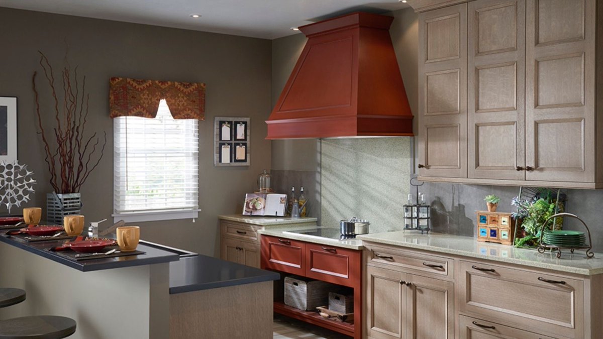 CabinetsDesigns's tweet photo. Soft, warm gray tone cabinets mix perfectly with a red cooktop base and hood in this @WoodMode kitchen. When designing your perfect kitchen, we take all aspects of design into consideration.  Reach out to us so, together, we can design your dream space. https://t.co/83BuBUUQtX