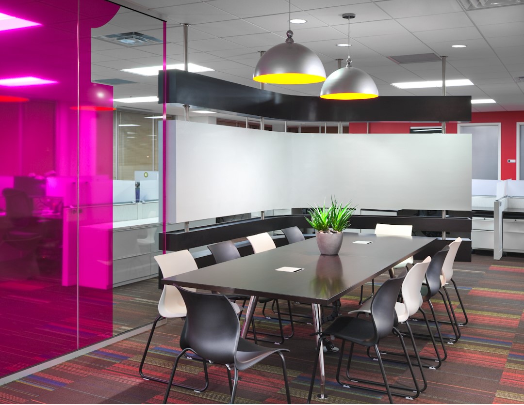 Seeing the world through rose colored lenses has never been easier. The fuchsia overlay of the glass modular walls gives this space a dynamic energy while the classic black and white chairs provide a sense of familiar comfort.

#furniture #interiordesign #commercialdesign