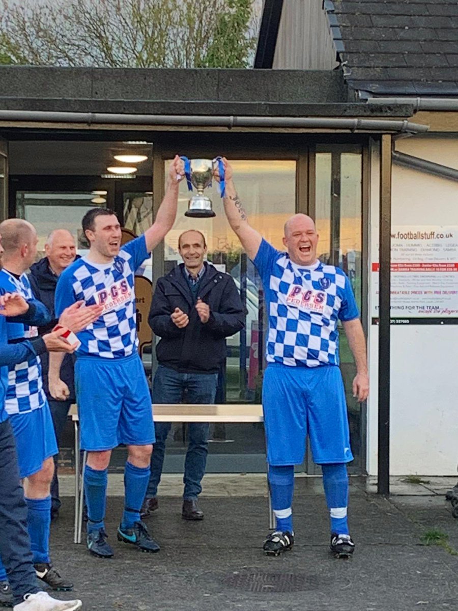 LouthTownFC's tweet photo. Congratulations to our Louth Town FC Cogs side, who tonight completed their unbeaten season in the East Lincs Combination, Division 3. Peter Herriman and TJ Rasmden lifting the League Trophy this evening. #COGS #Wolves ⚪️🔵⚪️🔵🐺🏆 https://t.co/E0UPtAxjKX