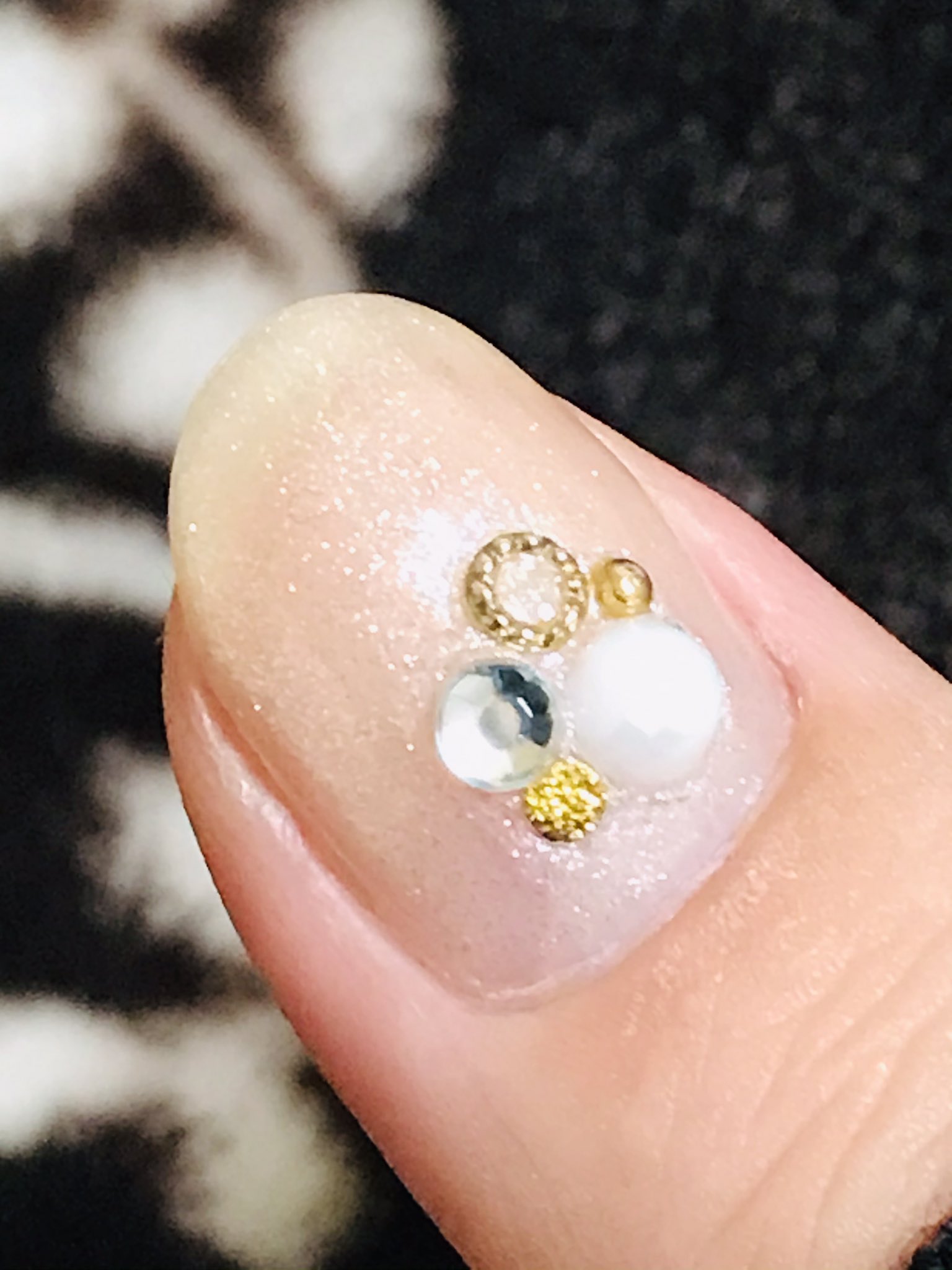 きょー 結婚式お呼ばれネイル グロッシーコートのシャンパンホワイトを使用 細かい白いラメが輝いて 上品なキラキラ パール ストーン スタッズで存在感をプラス 結婚式当日早朝に眠気と戦いながら試行錯誤したけど 頑張って良かった